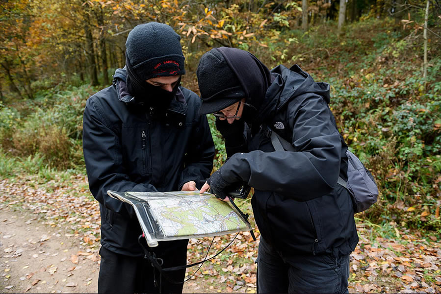 Sabs looking at a map and deciding where to go netx to stop the hunt